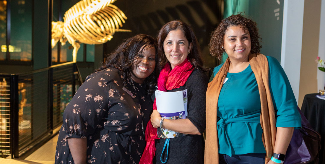 3 people pose for a photo at a private event