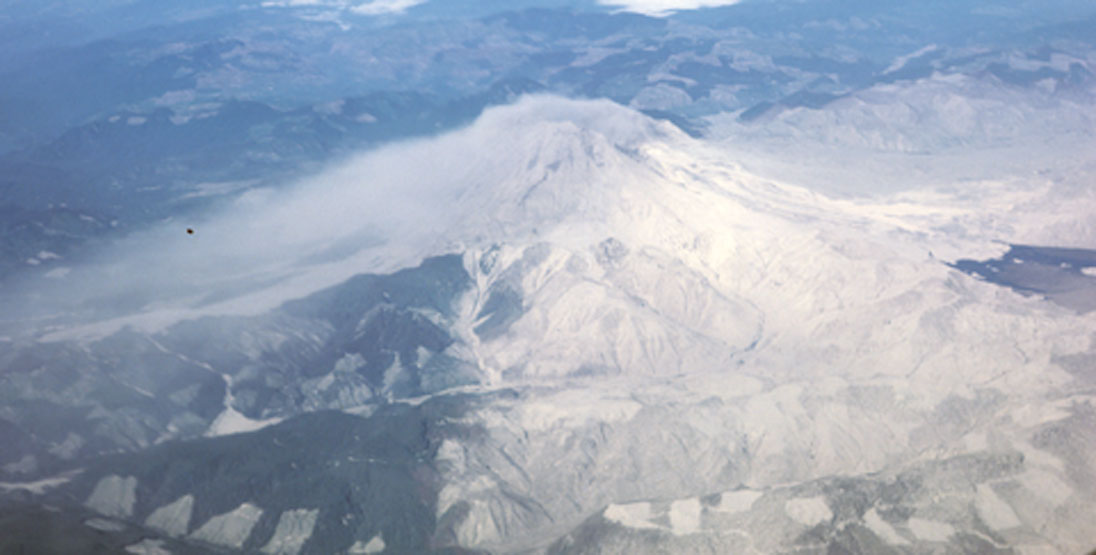 An aerial view of Mt St Helens post 1980 eruption shows where plants still grow and where the ash fell