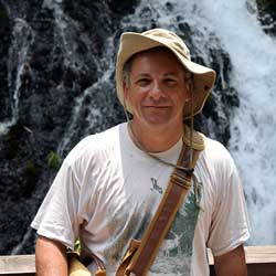 peter roopnarine standing in front of a waterfall