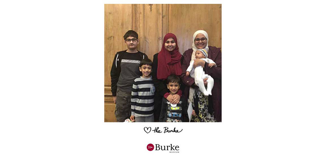 a family smiles for the camera in the Burke photobooth