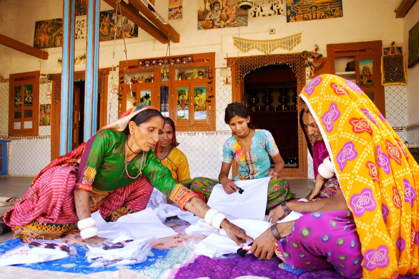 women wear colorful dresses while working in India