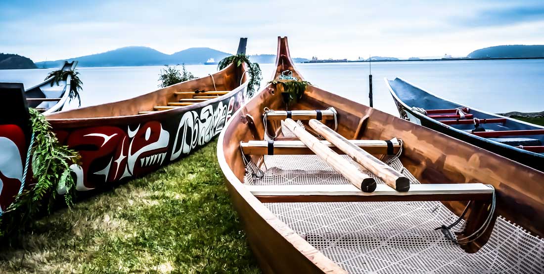 Samish tribal canoes are hauled out on the beach at Fidalgo Bay in Anacortes