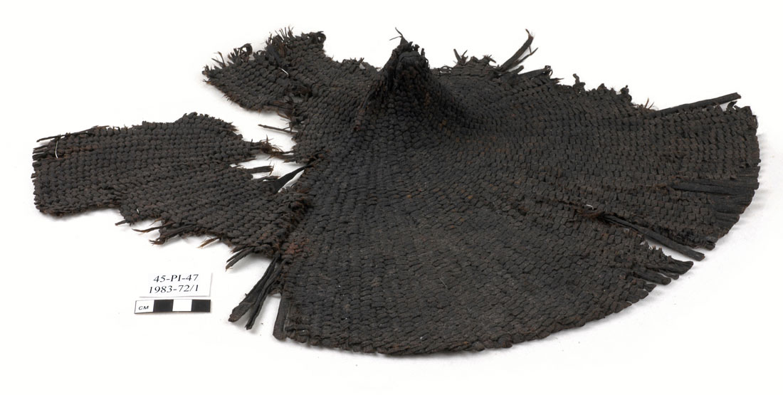 remnants of a dark woven hat found in an archaeological site