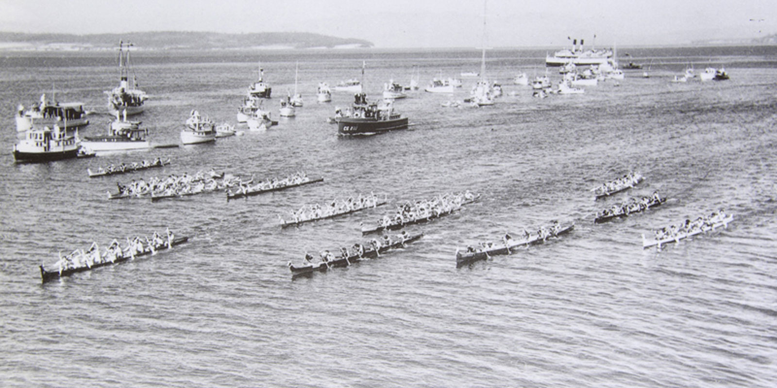 A 1934 photo of an eleven-boat canoe race