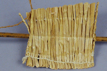 A cattail mat section with mat needle inserted