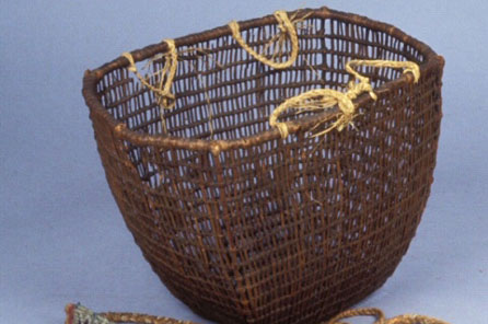 A completed woven basket with wide gaps between the woven rows