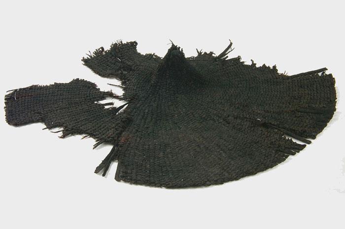 A large black hat with sections missing