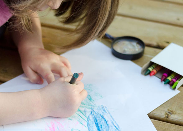 child makes a leaf rubbing