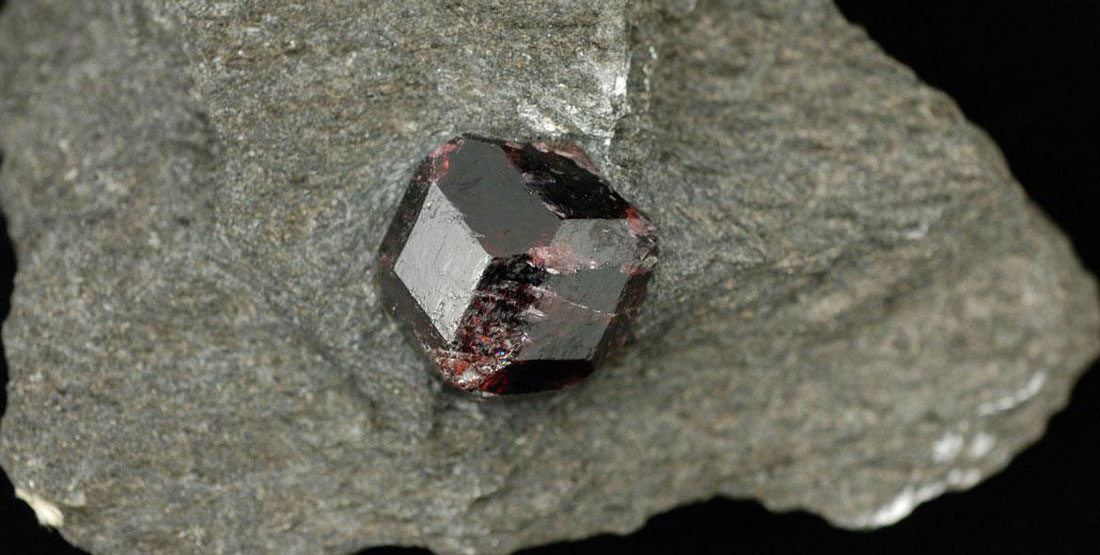 natural garnet polished gem on top