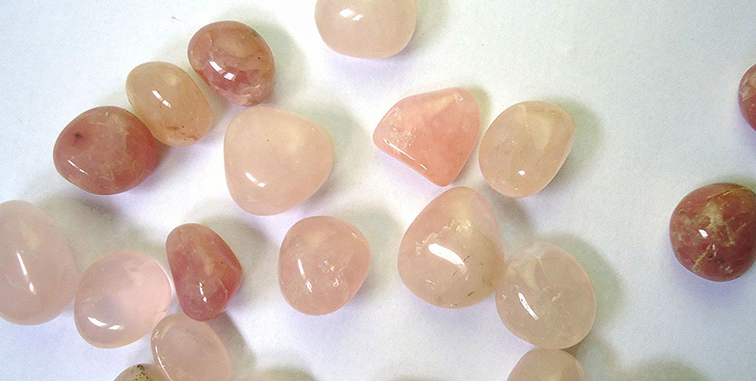 small rose quartz pebbles of varying shades of pink and red