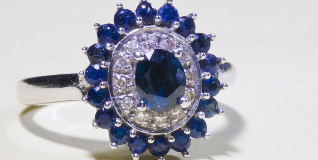 A ring with a sapphire and diamond layered pattern