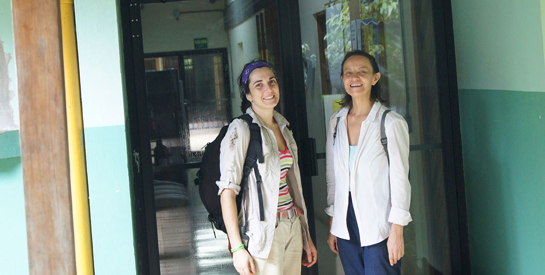 two women standing in front of a lab