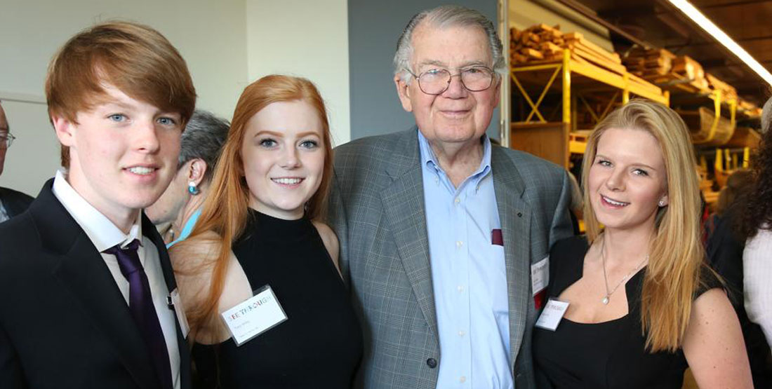 a grandfather, daughter and grandchildren pose for a photo