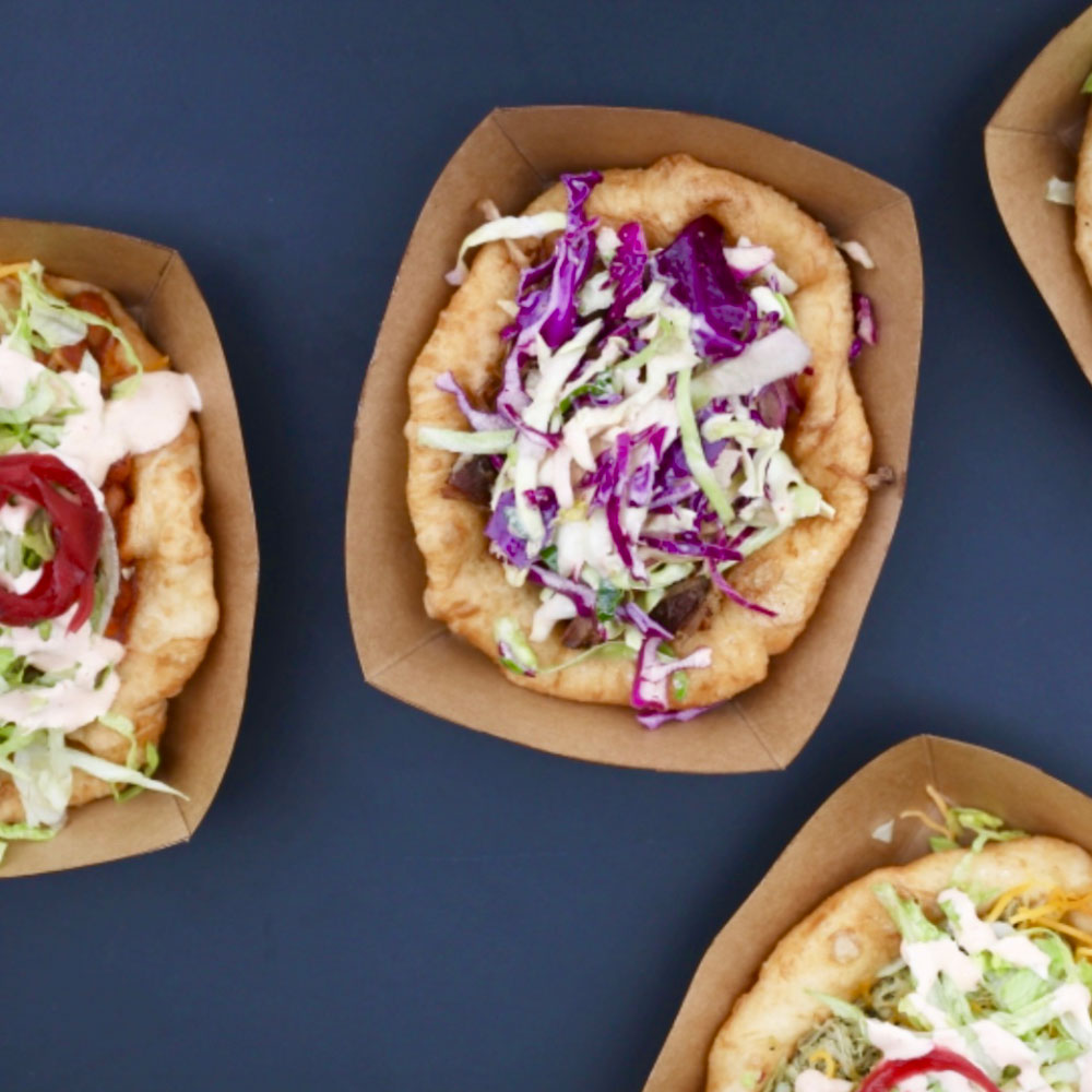 four plates of fry bread sit on a table