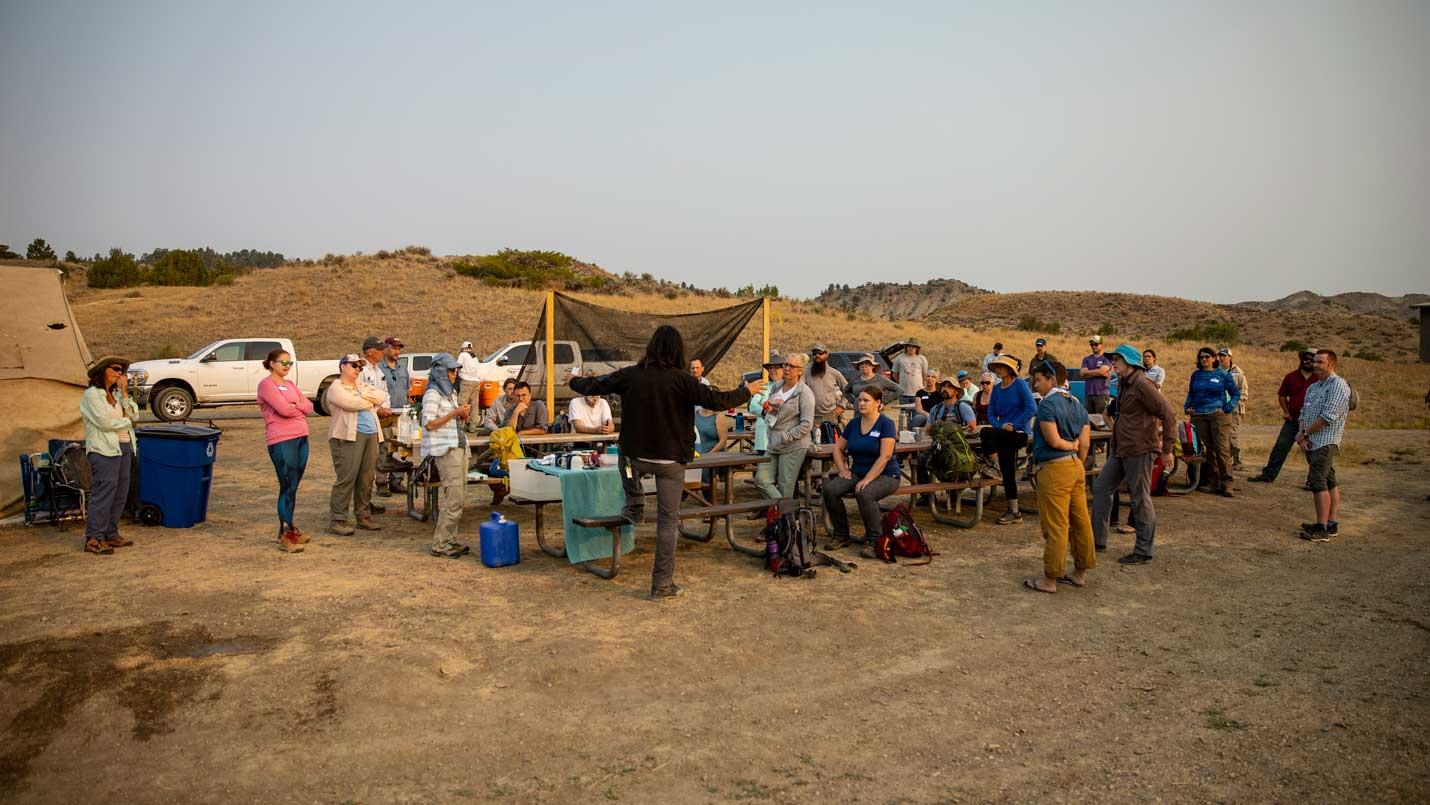 DIG Field School participants listen to a lesson in the field