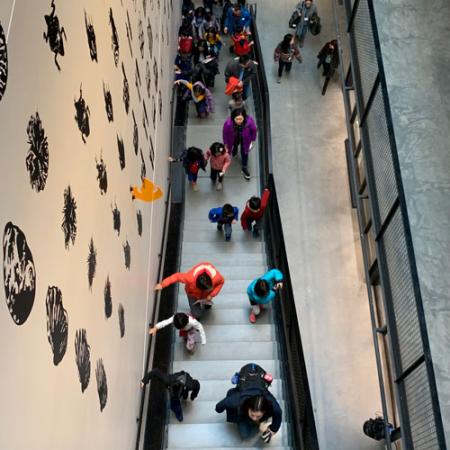 group of visitors on the stairs of the burke