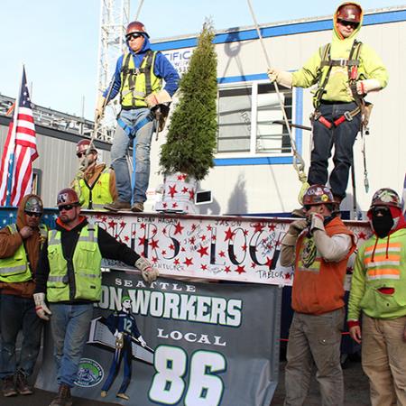 Eleven ironworks celebrate placing the final beam on the New Burke structure