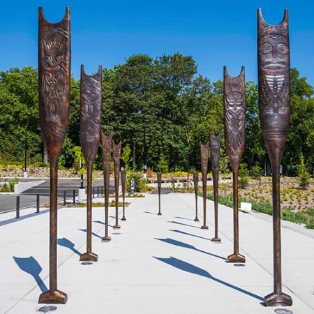 Bronze paddles glisten in the sun