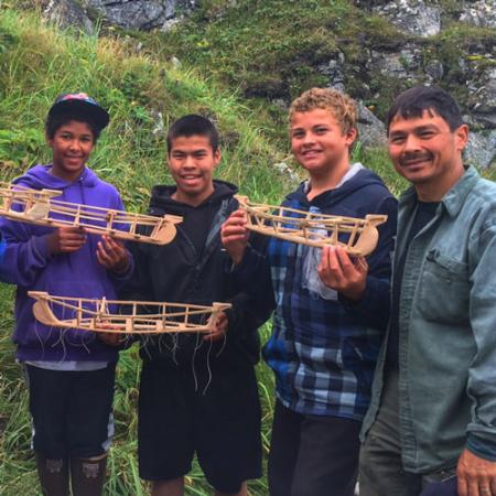 A group of young men holding model boats