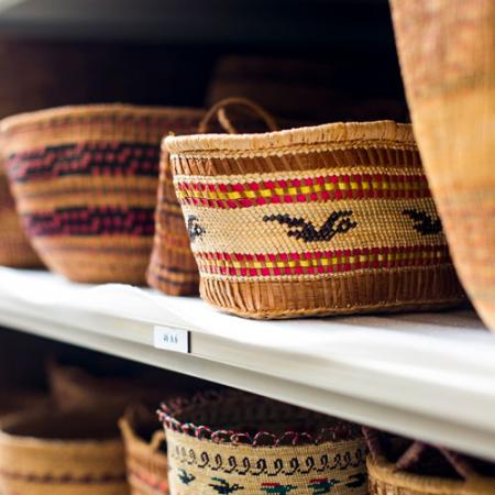 a row of baskets on the collection shelves
