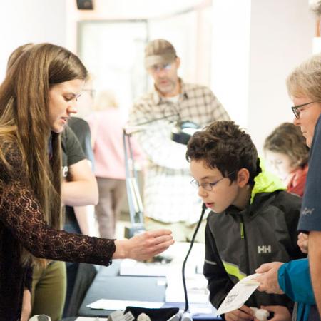 visitors learn about a specimen