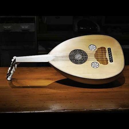 photo of an oud stringed instrument on a dark background