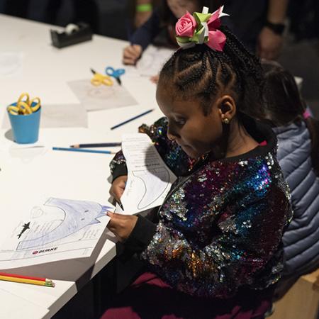 a kid in a sequin jacket does a shark craft