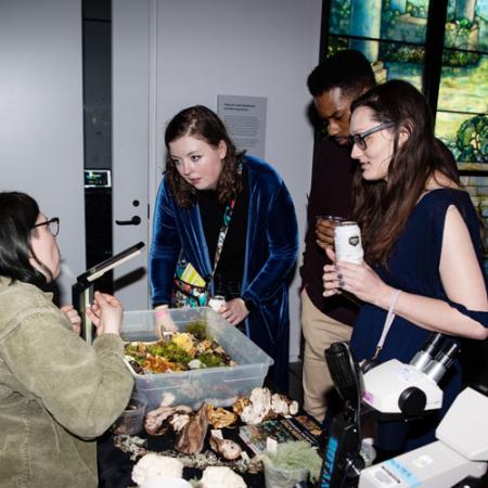 people learn about fungi at an after hours event