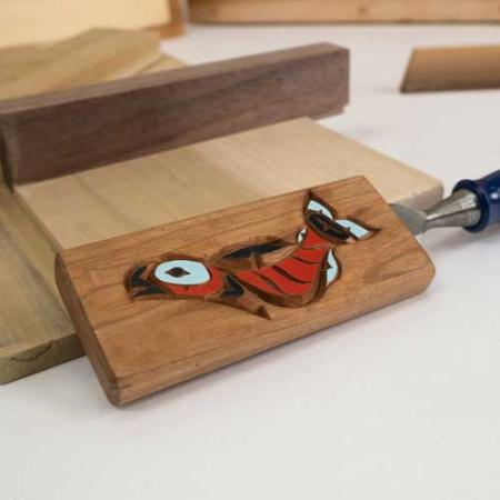 Detail of paring chisel cover, salmon on cherry by Camas Logue