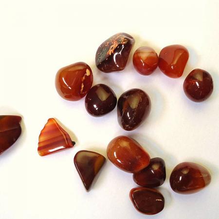 A group of small, round and smooth rubies of varying colors