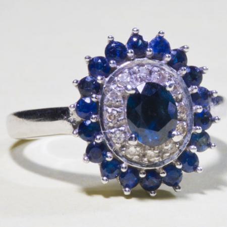 A ring with a sapphire and diamond layered pattern