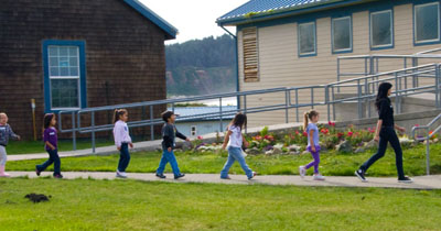 Children at the Quileute school following actress Tinsel Korey (Emily--New Moon).